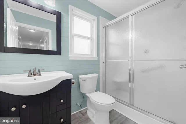 a front view of house with yard and trees in the background