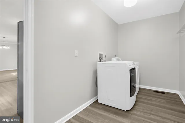 an empty room with chandelier fan