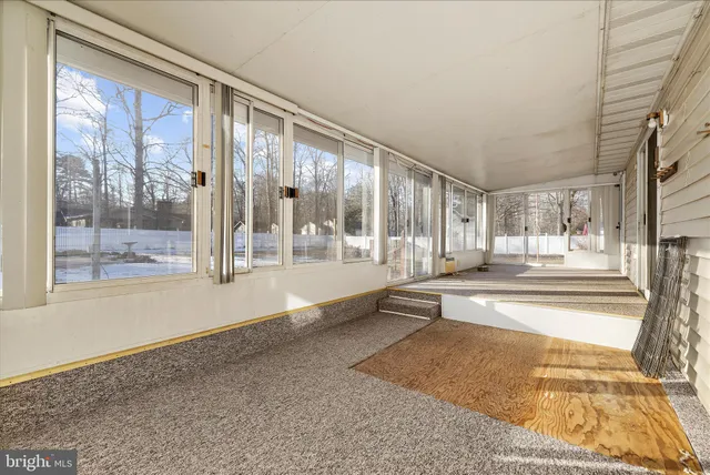 a view of a livingroom with a ceiling fan and wooden floor