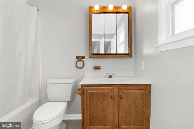 a view of a house with snow on the side of the road