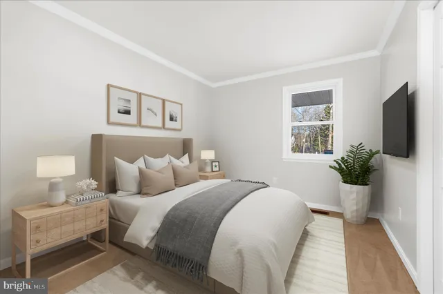 a bedroom with a large bed and a flat screen tv