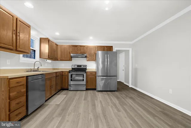 a kitchen with a sink stove and cabinets