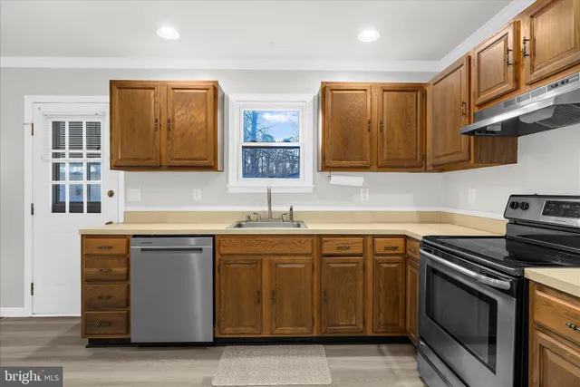 a kitchen with a sink stove and refrigerator