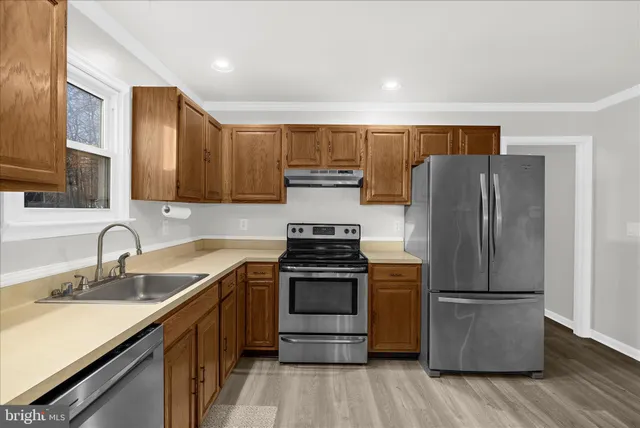 a bathroom with a sink mirror vanity and toilet