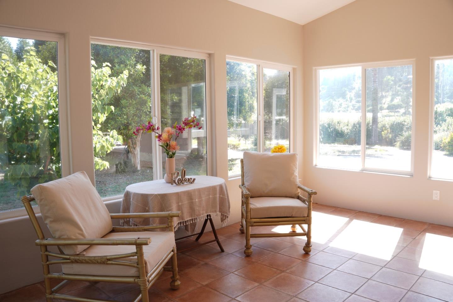 389 Corralitos Road Watsonville, CA 95076 - Photo 9 of 18 a living room with furniture and large windows