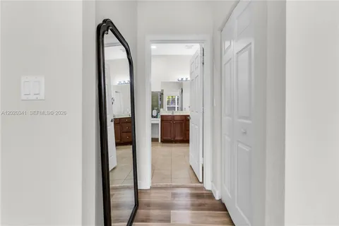 a view of a hallway view with wooden floor and staircase