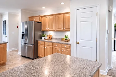 a kitchen with stainless steel appliances granite countertop a refrigerator and a sink
