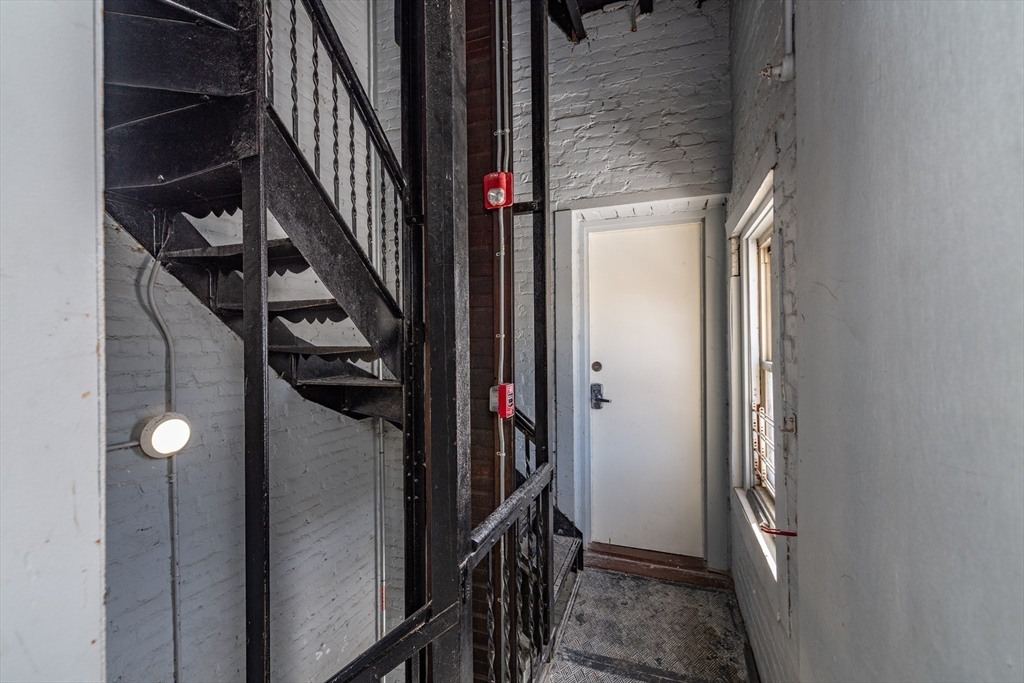 301-305 Dudley Street Boston, MA 02119 - Photo 13 of 14 a view of hallway with stairs and wooden floor