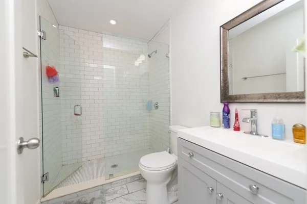 a bathroom with a sink toilet and shower