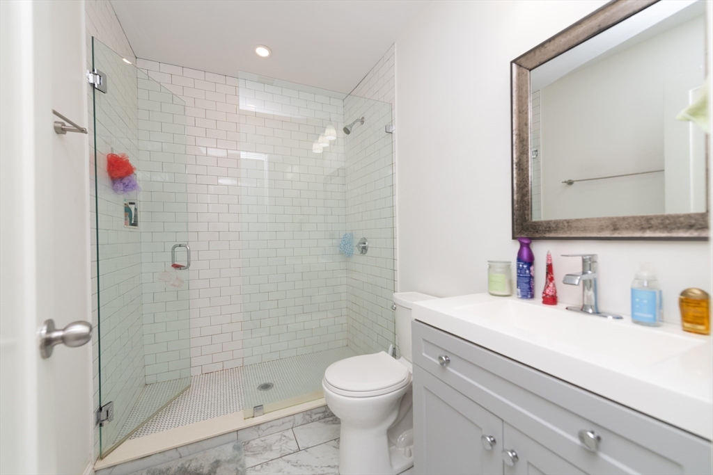 301-305 Dudley Street Boston, MA 02119 - Photo 10 of 14 a bathroom with a sink toilet and shower