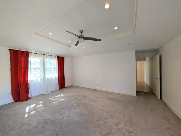 a view of a livingroom with a ceiling fan and window