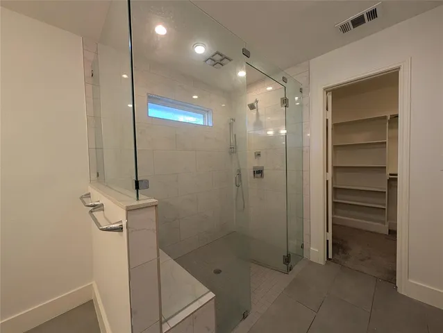 a bathroom with a shower and a sink