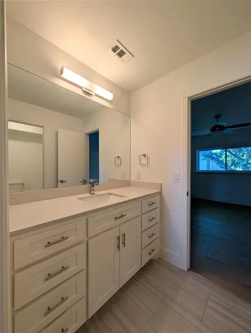 a spacious bathroom with a double vanity sink and a mirror