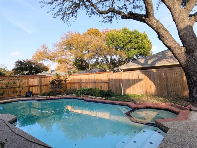 a view of a backyard with swimming pool