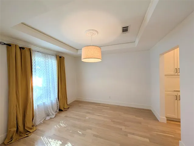 an empty room with windows and entrance