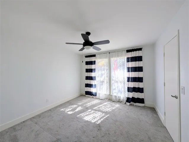 a view of a livingroom with a large window and a window