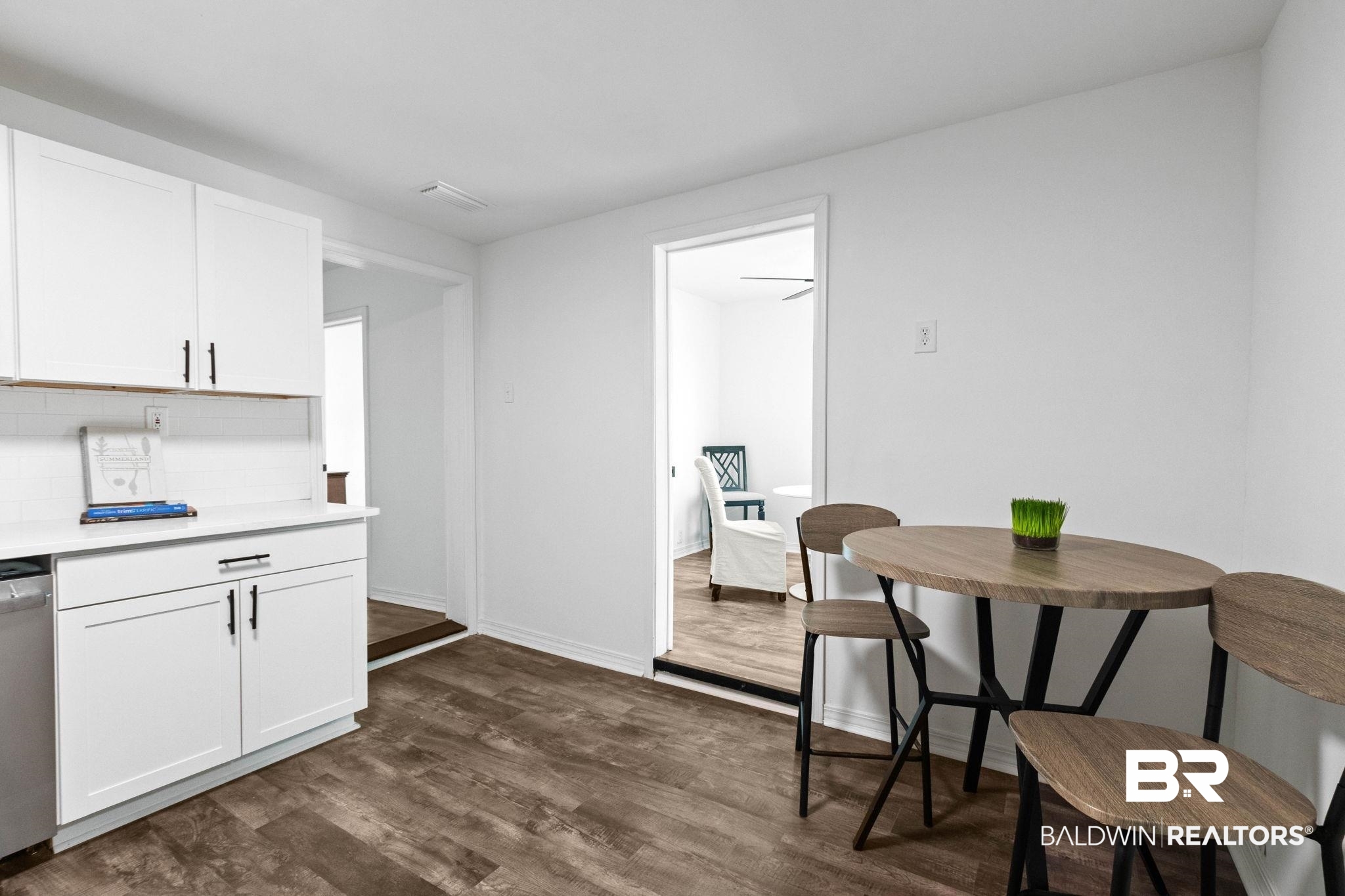 128 Bush Avenue Mobile, AL 36604 - Photo 12 of 40 Dining room with dark wood-style flooring and baseboards