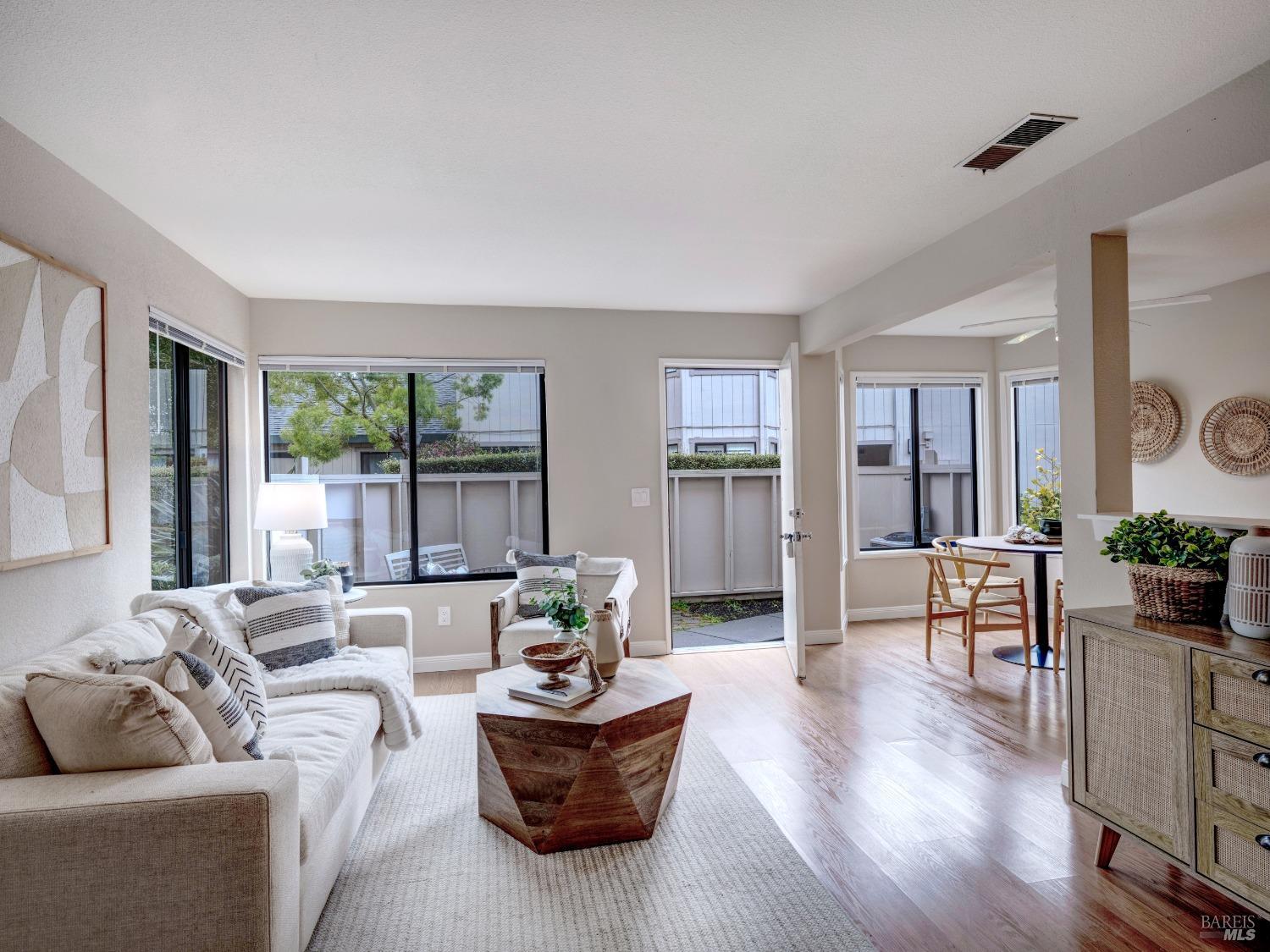 65 Dockside Circle San Rafael, CA 94903 - Photo 1 of 1 a living room with furniture and large windows