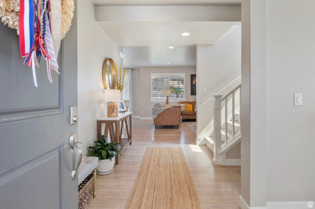 1295 East Granite Peak Road Eagle Mountain, UT 84005 - Photo 7 of 35 Entryway featuring wood-finish flooring, recessed lighting, and a white staircase with spindle railing