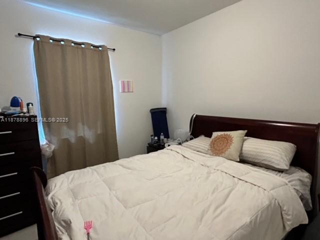 11914 Southwest 241st Street Homestead, FL 33032 - Photo 13 of 25 a bedroom with a bed and a mirror