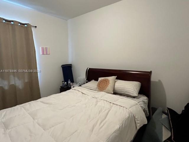 11914 Southwest 241st Street Homestead, FL 33032 - Photo 14 of 25 a bedroom with a bed and a black mirror