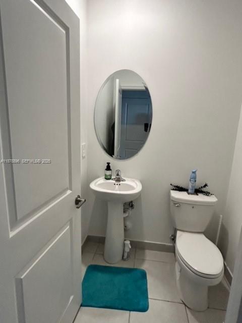 11914 Southwest 241st Street Homestead, FL 33032 - Photo 21 of 25 a bathroom with a toilet a sink and a mirror