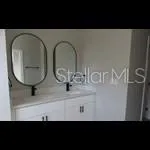 a view of a bathroom with sink and mirror