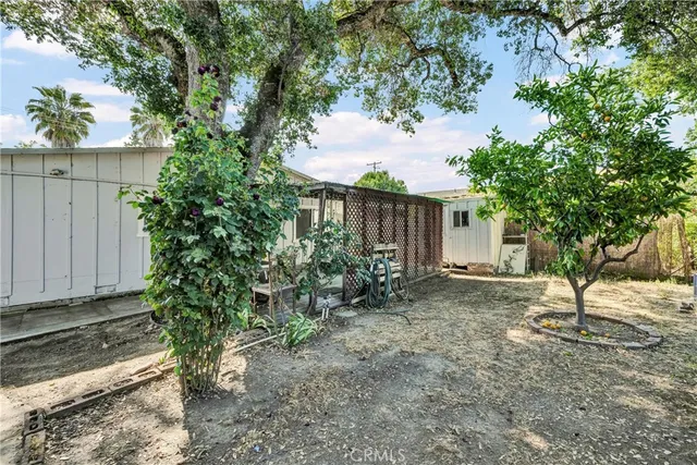 a backyard of a house with table and chairs