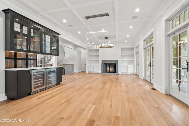 a open kitchen with kitchen island a stove a refrigerator cabinets and living room view