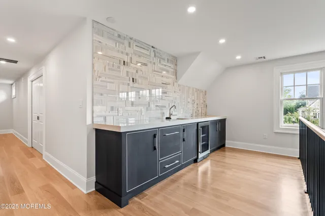 a spacious bathroom with a granite countertop double vanity and a mirror