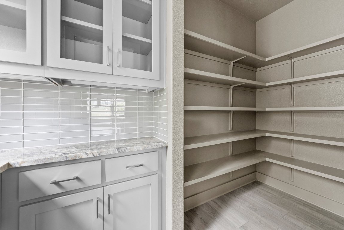 8108 Turning Leaf Circle Lago Vista, TX 78645 - Photo 11 of 40 A butler’s pantry and walk-in storage space that’s ready for everything from baking marathons to holiday hosting.
