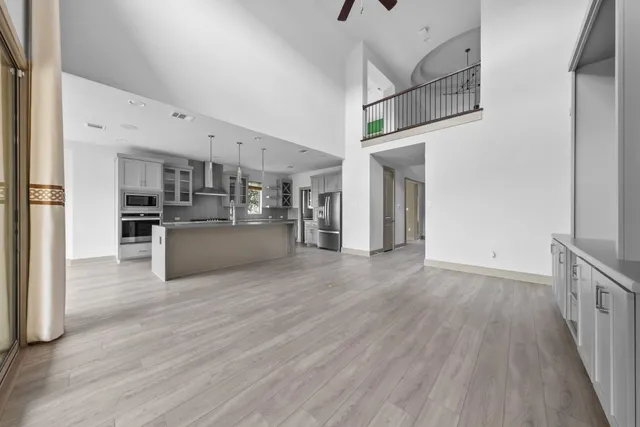 a view of a kitchen with a sink and a refrigerator