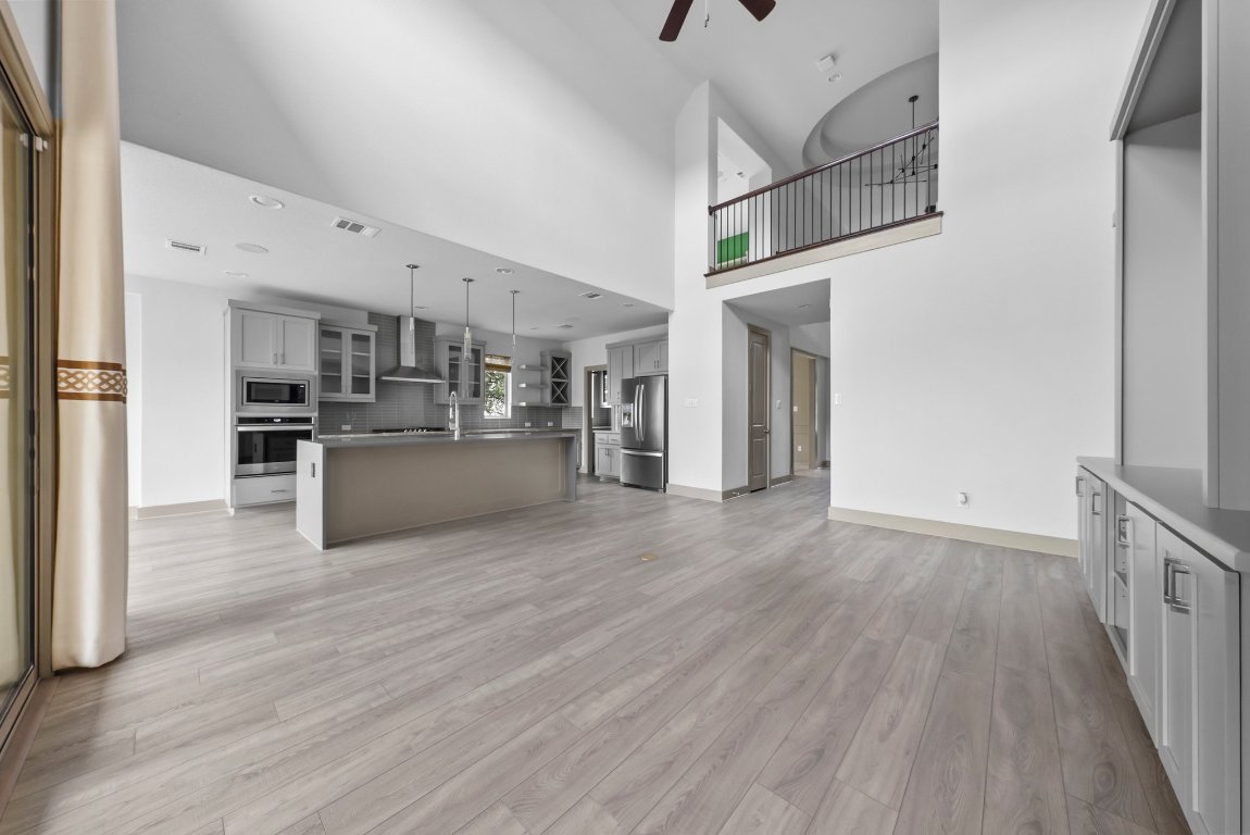 8108 Turning Leaf Circle Lago Vista, TX 78645 - Photo 13 of 40 Open-concept living with soaring ceilings and plenty of room to spread out or gather in.