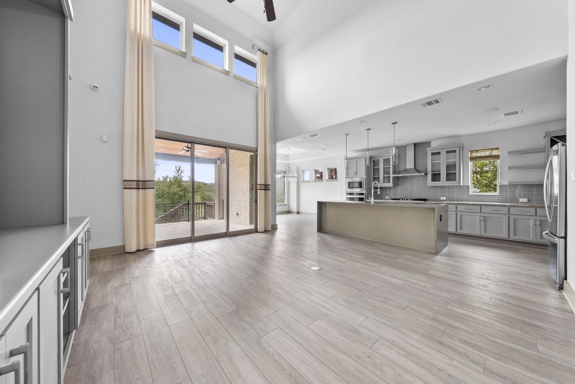8108 Turning Leaf Circle Lago Vista, TX 78645 - Photo 14 of 40 Wall-to-wall windows and sliding doors bring in natural light and lead straight to those Hill Country views.