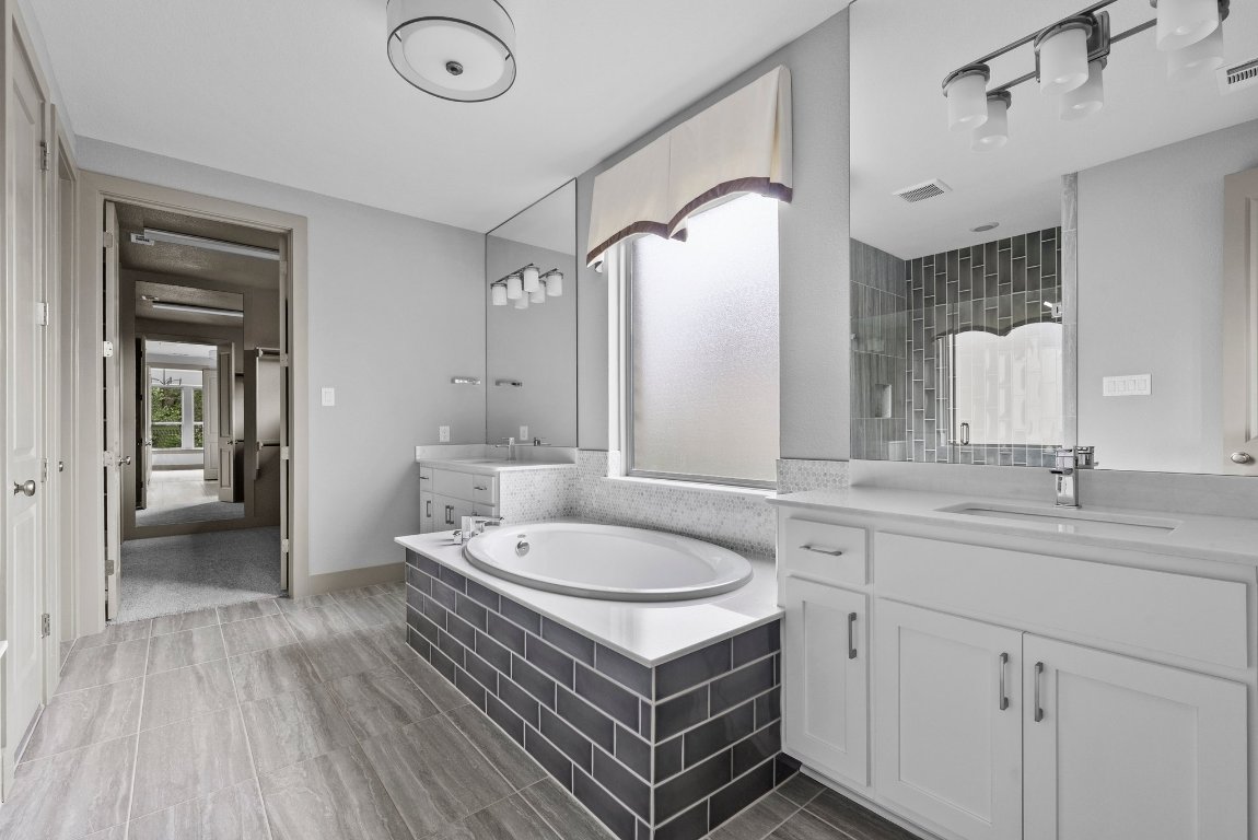 8108 Turning Leaf Circle Lago Vista, TX 78645 - Photo 16 of 40 Spa-level design meets real-life function in this stunning primary bath with space to spread out.