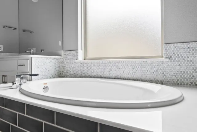 a bathroom with a bathtub and a sink