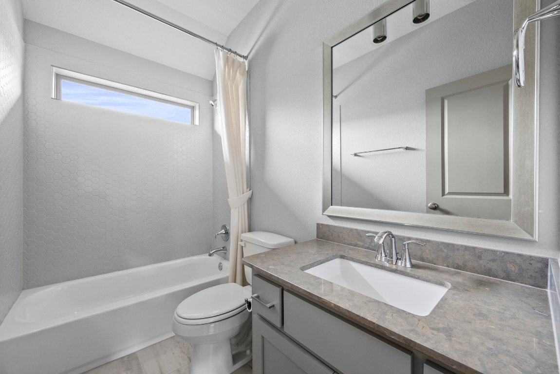 8108 Turning Leaf Circle Lago Vista, TX 78645 - Photo 27 of 40 Crisp and clean guest bath featuring sleek tilework, modern fixtures, and elevated natural light.