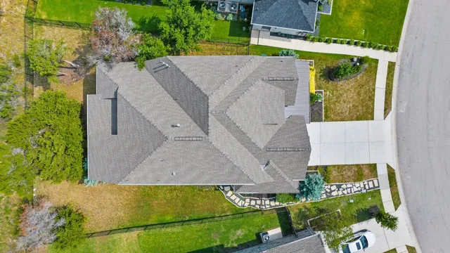an aerial view of a house with a yard