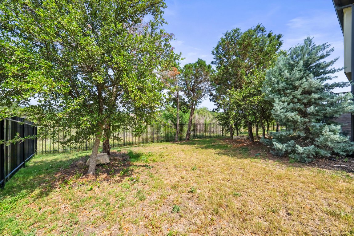 8108 Turning Leaf Circle Lago Vista, TX 78645 - Photo 39 of 40 A quiet canopy of trees adds privacy and natural charm to this generous backyard retreat.