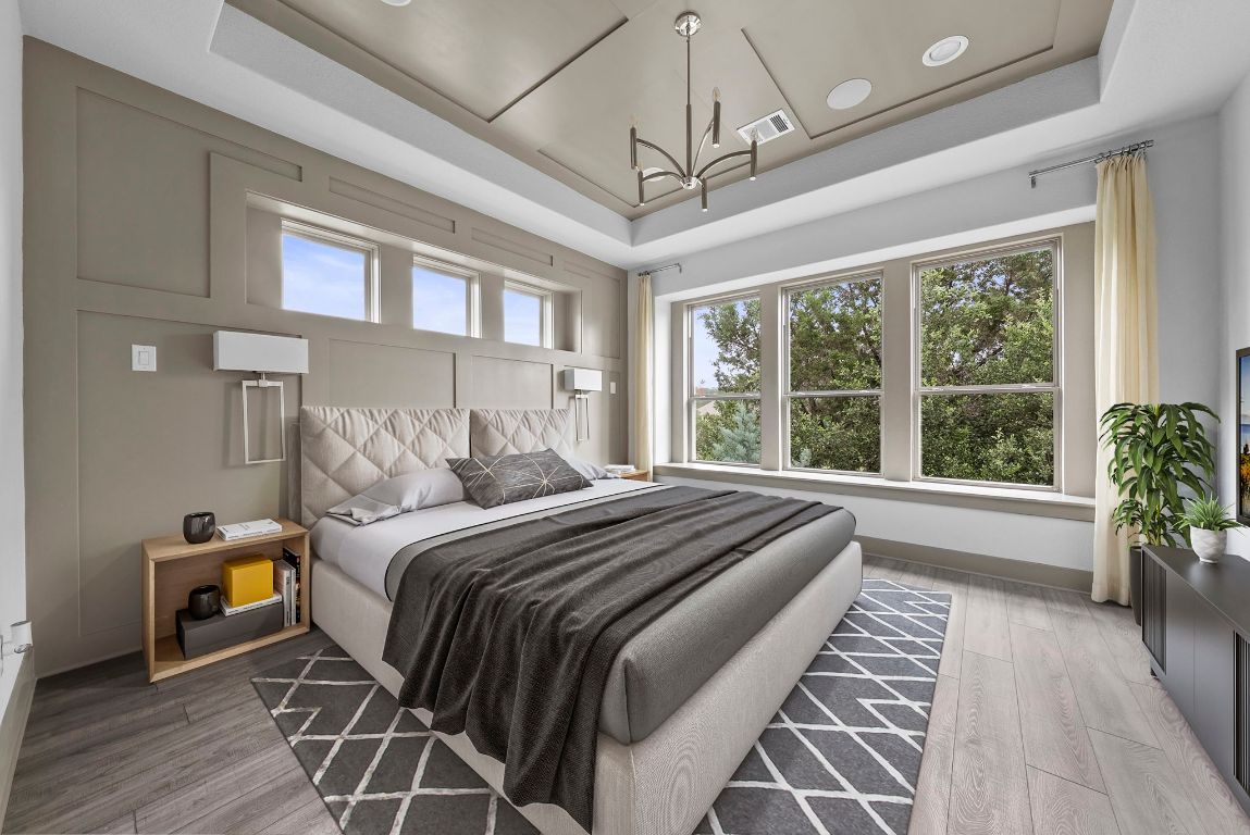 8108 Turning Leaf Circle Lago Vista, TX 78645 - Photo 6 of 40 The primary suite is a true standout, featuring elegant tray ceilings, paneled walls, and a sleek designer light fixture that ties it all together. - Virtually Enhanced