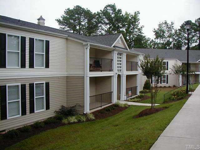 2216 Myron Drive, Unit 101 Raleigh, NC 27607 - Photo 2 of 7 a front view of a house with a yard and trees