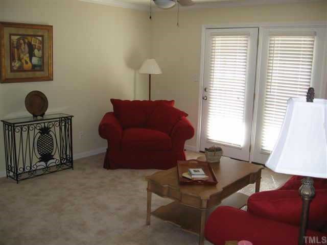 2216 Myron Drive, Unit 101 Raleigh, NC 27607 - Photo 3 of 7 a living room with furniture a window and a lamp