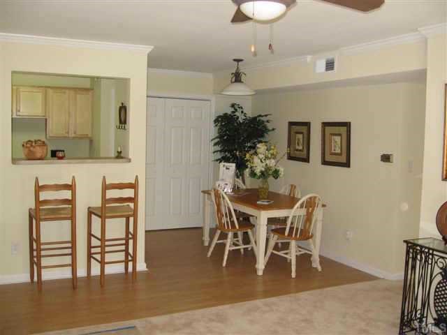 2216 Myron Drive, Unit 101 Raleigh, NC 27607 - Photo 4 of 7 a dining room with furniture and wooden floor