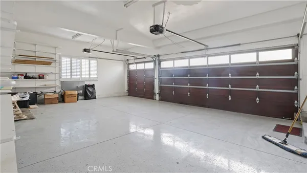 a room with lots of wooden furniture and windows