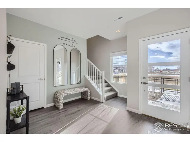 a view of an entryway with wooden floor