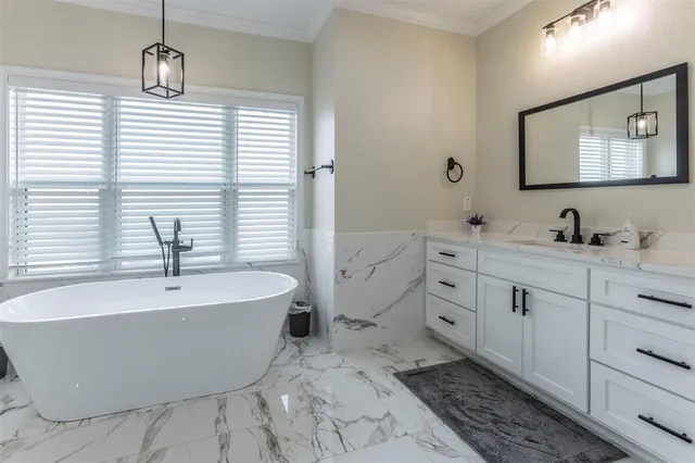 a bathroom with a bathtub and a sink