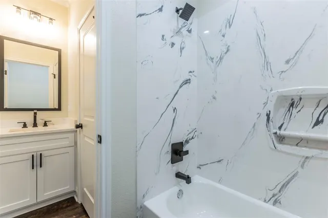 a bathroom with a bathtub and a sink