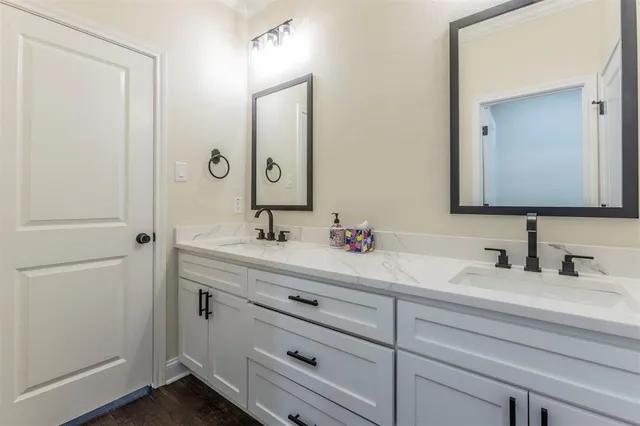 a bathroom with a double vanity sink mirror and