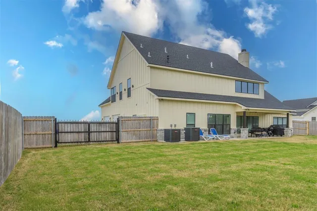 a view of a house with a yard and sitting area