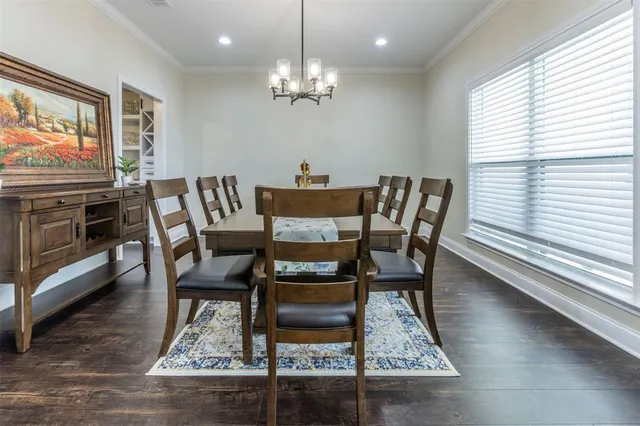a dining room with furniture a rug and wooden floor
